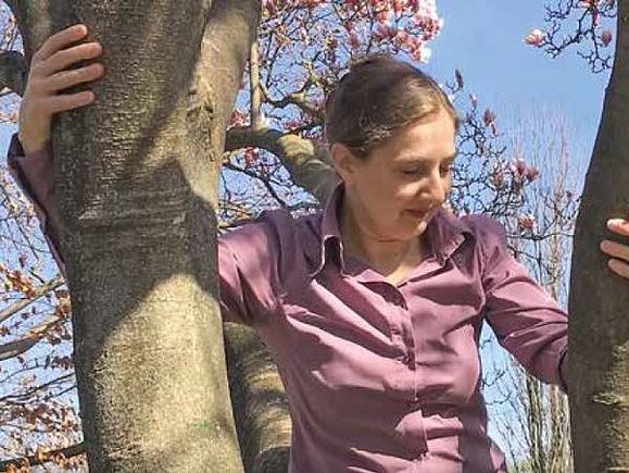 In Schönbrunn kann Anna Morawetz sich gut entspannen. Frau mit rosa gekleideten Oberteil und entspanntem Gesicht in Baumkrone